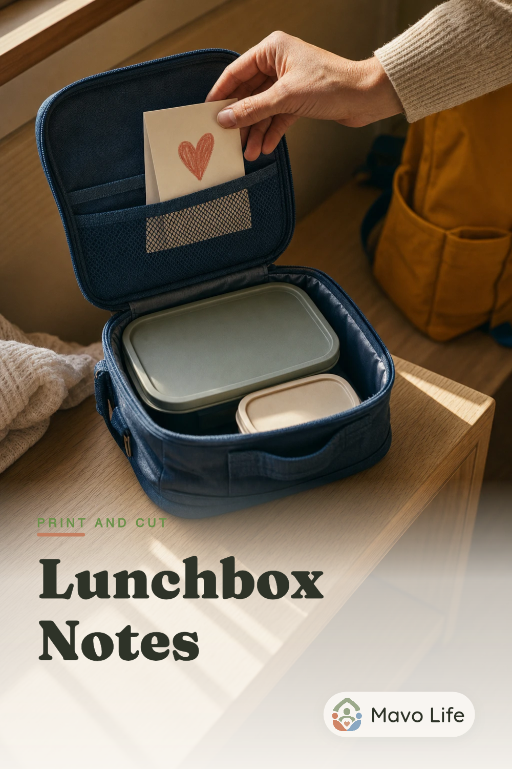A hand slips a heart-marked folded note into a blue lunch bag. The image reads Lunchbox Notes.